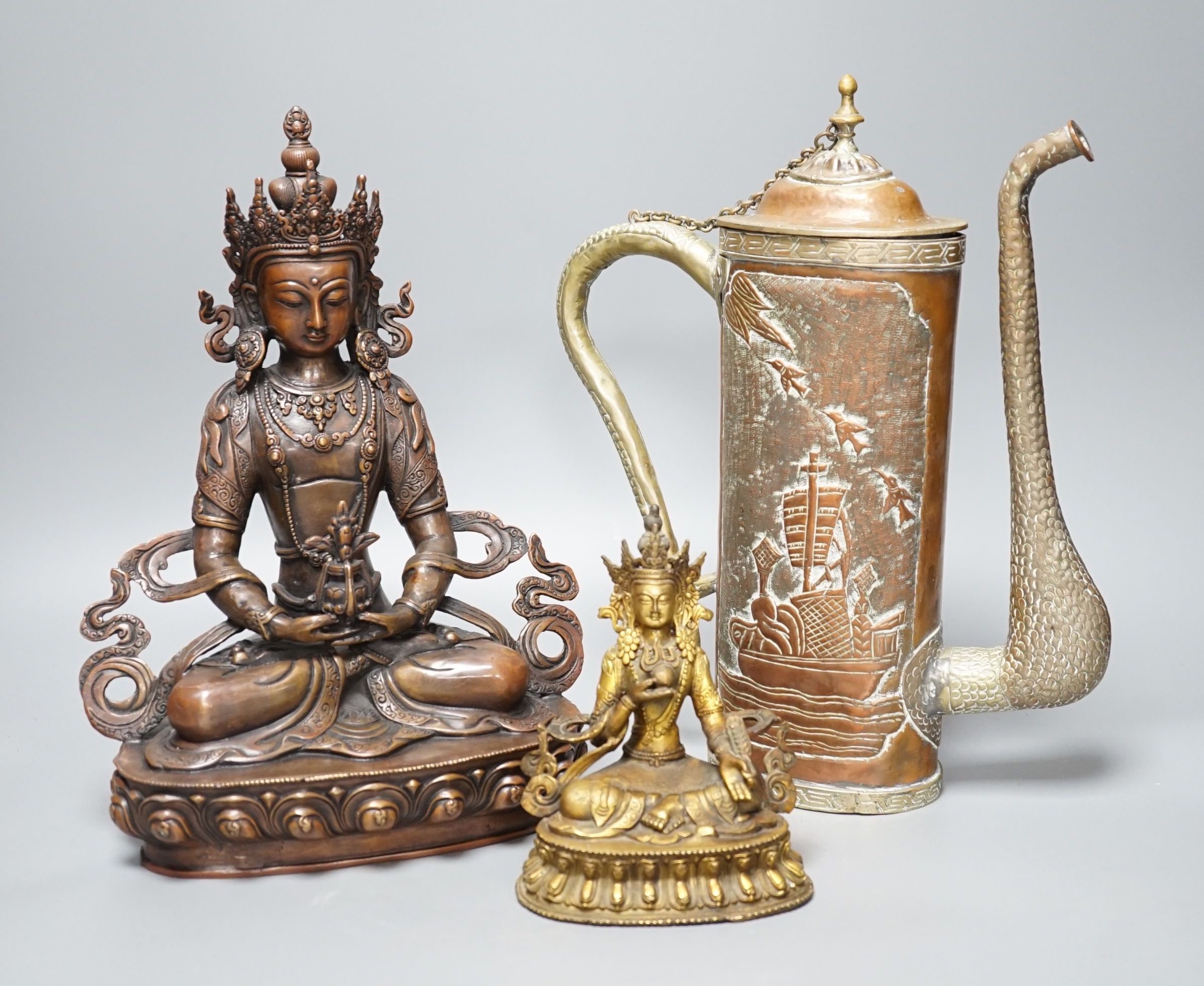 A Tibetan copper and brass ewer, together with a gilt-metal bodhisattva and another bronze bodhisattva, tallest 31cm